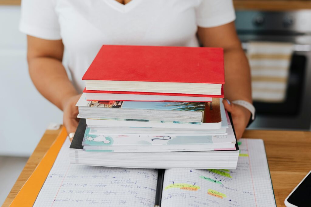 A stack of books and study materials on the desk.