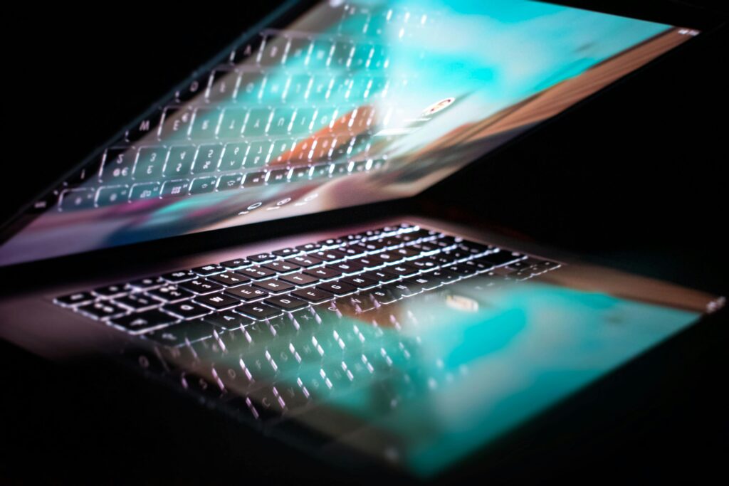 Close-up of hands typing on laptop.