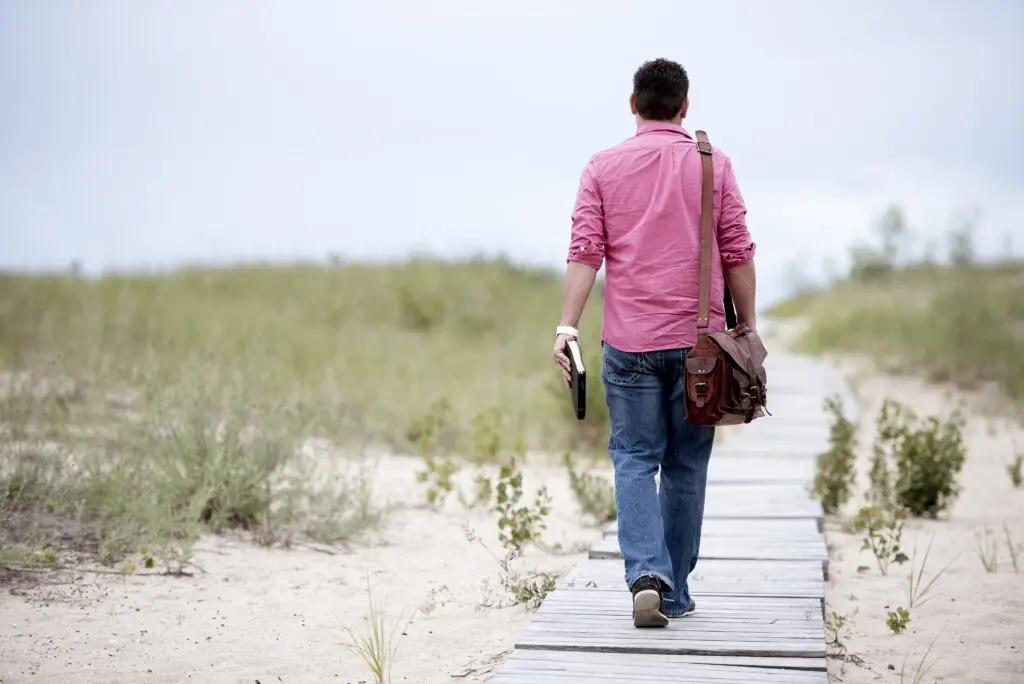 A person standing on a path, symbolizing a journey of discovery and learning.