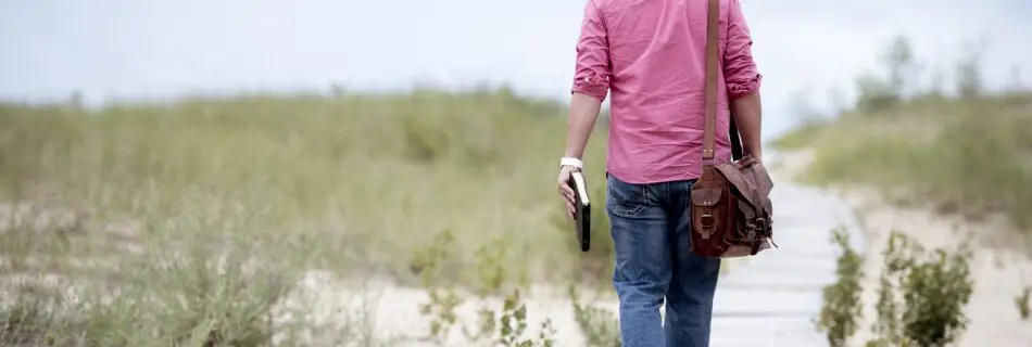 A person standing on a path, symbolizing a journey of discovery and learning.