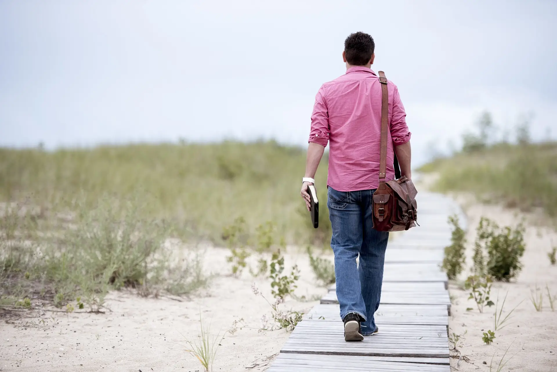 A person standing on a path, symbolizing a journey of discovery and learning.