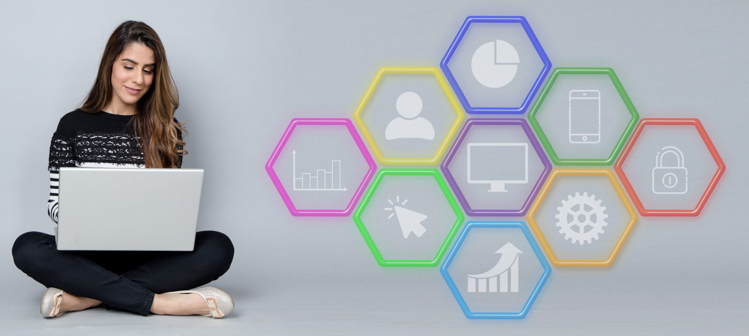 A person working on a laptop with colorful hexagonal icons representing SEO strategies, including charts, mobile devices, security, and growth metrics, symbolizing digital marketing optimization.