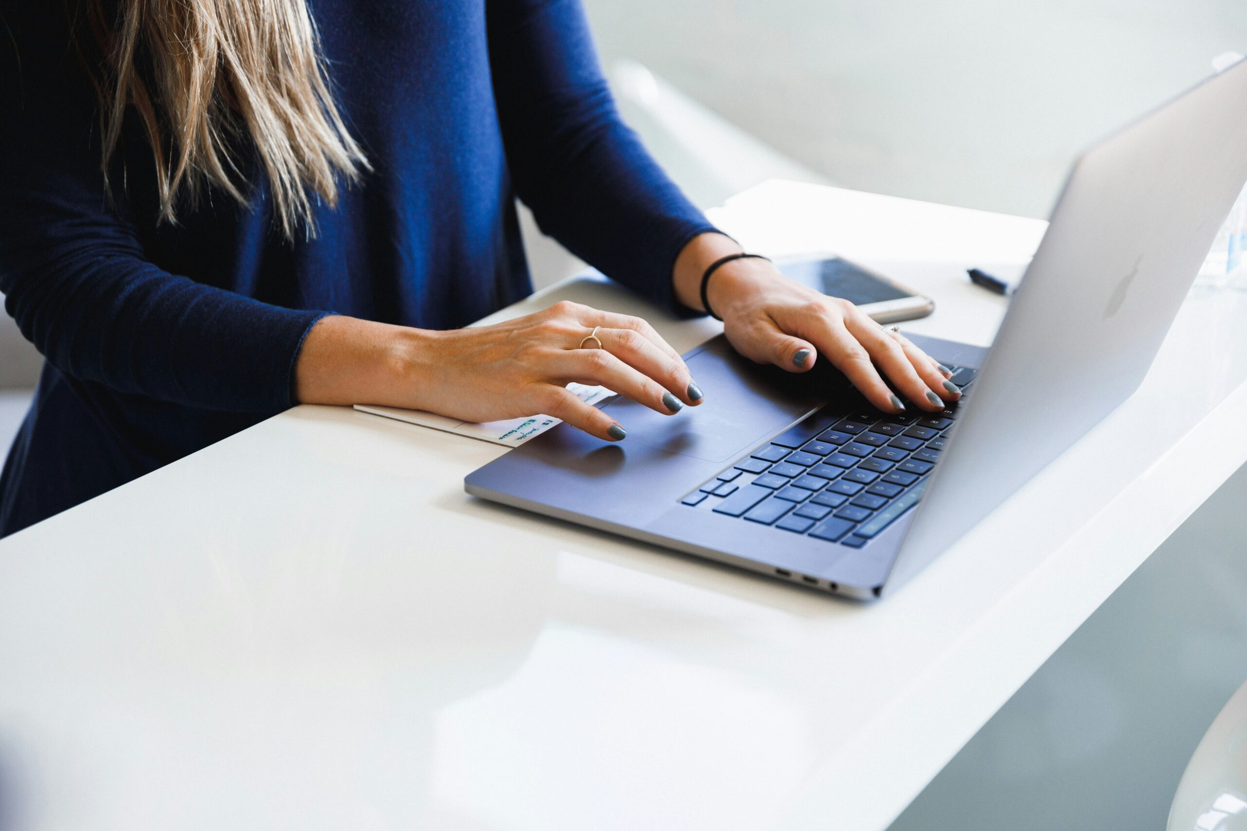 A person working on a laptop to measure off-page SEO success, focusing on backlinks, referral traffic, and social engagement metrics.